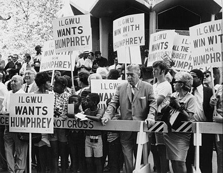 International Ladies' Garment Workers' Union supporters hold signs during a Humphrey rally.
