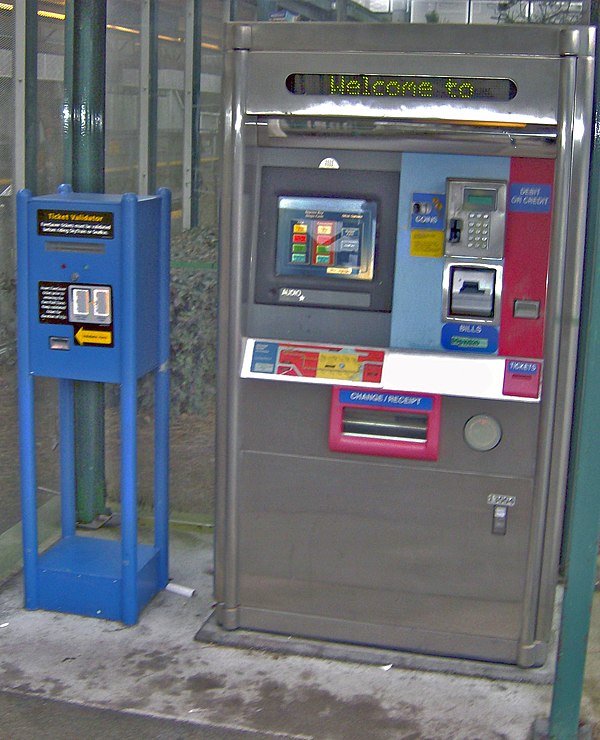 A ticket vending machine (right), next to an old faresaver validator (2006)