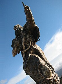 View of the monumental bronze sculpture, St Brendan the Navigator, created by Tighe O'Donoghue/Ross for the St Brendan Heritage Park atop Samphire Island at Fenit, County Kerry, Ireland St. Brendan from below.jpg