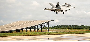 Super Hornet taking off from a ski jump ramp.jpg