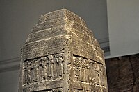 Part superior de l'obelisc en forma de zigurat i amb escriptura cuneïforme.