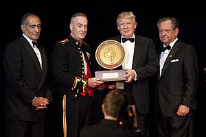 Trump receiving the 2015 Marine Corps-Law Enforcement Foundation's annual Commandant's Leadership Award in recognition of his contributions to American military education programs Trump MarineCorpsFoundation April22 2015.JPG