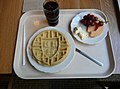A breakfast consisting of a novelty-stamped waffle, cantaloupe melon slices, grapes, and butter. Photo taken in Currier House of Harvard College