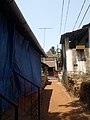 Village road, Saligao. To left (covered in blue plastic) is the one-time house of the artist FN Souza.jpg