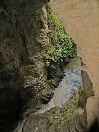 Waitomo Stream flows beneath Ruakuri natural arch. Waitomo Stream.jpg