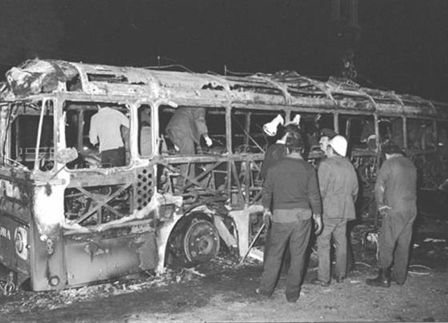 Remains of the hijacked bus being inspected shortly after the attack