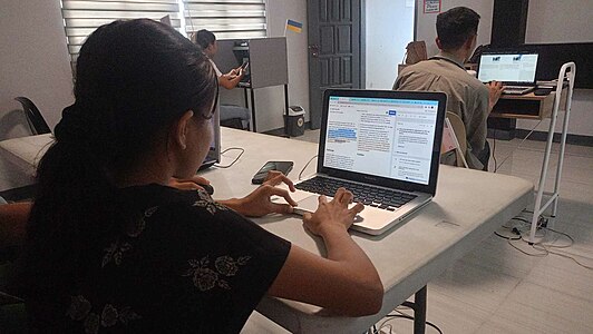 A volunteer doing her edits