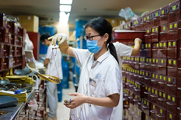 Apothecary mixing traditional Chinese medicine at Jiangsu Chinese Medical Hospital, Nanjing, China