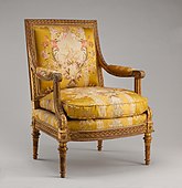 Fotoliu (fauteuil) Ludovic al XVI-lea; 1788; lemn de nuc sculptat și aurit, cu mătase brocată cu aur (nu e originală); 100 × 74,9 × 65,1 cm; Muzeul Metropolitan de Artă