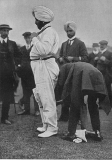 Maharajah Bhupinder Singh of Patiala (1911) having his pads adjusted before going in to bat. Bhupinder Singh of Patiala; The Maharajah goes a-cricketing.png