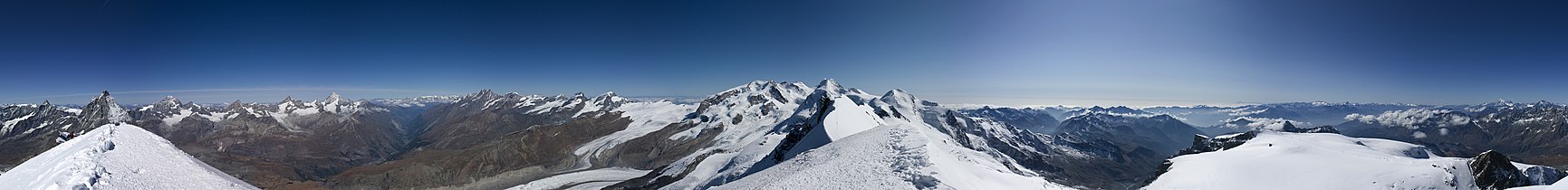 Panorama from peak, in left side: mountain Matterhorn. Valley Mattertal, Zermatt and Gornergrat. A view to Monte Rosa massif and Liskamm.