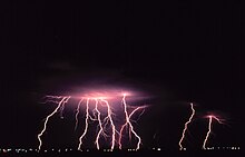 Lightning strikes Norman during a nighttime thunderstorm