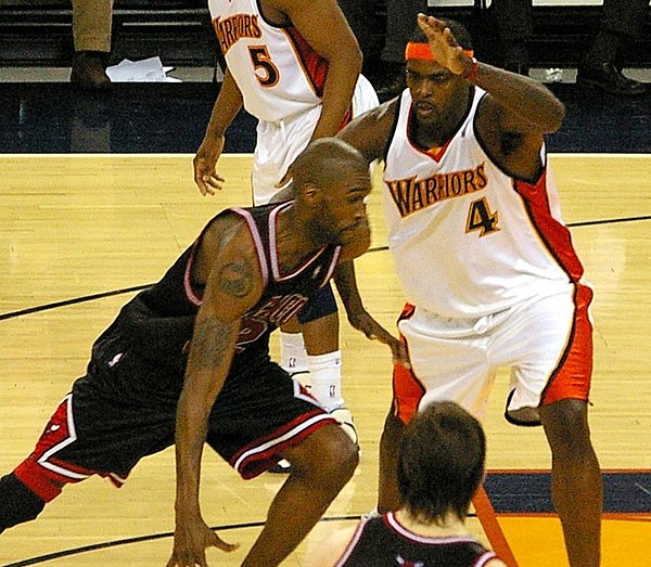 Smith (left) driving against the Warriors' Chris Webber (#4) with the Bulls in 2008
