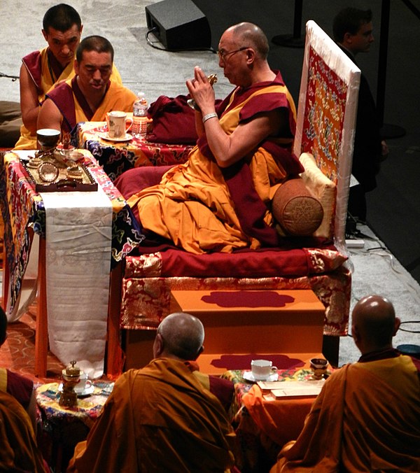 His Holiness the 14th Dalai Lama holds a vajra offering mudra while preparing the Kalachakra mandala during a Kalachakra initiation ceremony in Washin