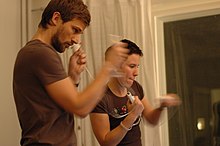 Two people playing boxing; the Wii Remote and Nunchuk are used here to control punches. Duo playing Wii Sports.jpg