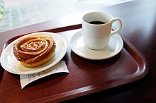 Swedish custom of fika, featuring coffee and kanelbullar, a Swedish cinnamon roll Fika kaffe bulle.jpg