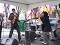 Tristin Chanel (right) playing a didgeridoo with her band Five Star Affair in Calgary in 2007