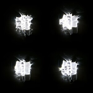 "Four_versions_of_a_floodlight_through_rain_on_a_window.jpg" by User:W.carter