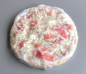 A wrapped, mass-produced frozen pizza to be cooked at home