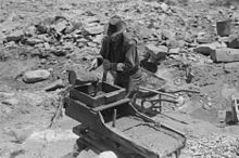 Gold prospector pouring water through his rocker box, Pinos Altos, New Mexico (1940). Gold mining rocker box.jpg