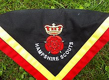 A scout neckerchief of Hampshire Scouts showing a double red rose and gold crown Hampshire Scouts necker.jpg