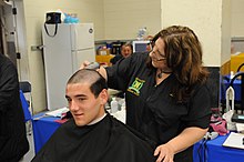 A member of the U.S. Naval Academy's incoming Class of 2019 gets his first military haircut on Induction Day Induction Day hair cut 150701-N-TO519-054.jpg