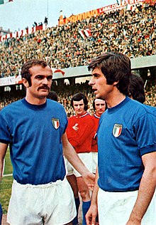 Sandro Mazzola (left) playing for Italy alongside Gianni Rivera (right); the two playmakers would be involved in manager Ferruccio Valcareggi's infamous staffetta policy at the 1970 World Cup. Italy v Luxembourg (Genoa, 1973) - Mazzola and Rivera.jpg