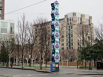 One of the totem poles that also function as support poles for the Portland Streetcar's overhead wire. Jamison Square, NW Portland, OR 2012.JPG