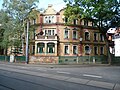 Apartment house in a corner and open development