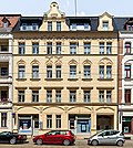 Apartment building in closed development, with shop with original front