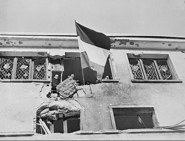 Civilians in Wiltz flying the flag of Luxembourg during the town's liberation by U.S. forces