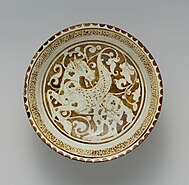 Late 12th century. Made in Iran. Stonepaste; luster-painted on opaque monochrome glaze. H. 8.3 cm, Diam. 20.3 cm. Luster Bowl with Winged Horse.jpg