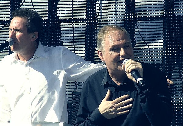 OMD performing in 2011. The band were keen to approximate their live form on Crush, although producer Stephen Hague opted to introduce a more polished