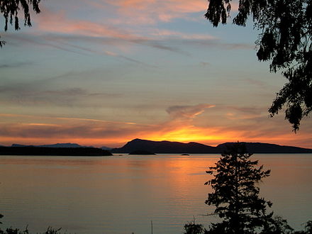 the sun setting over Waldron Island and the Canadian Gulf Islands in the distance