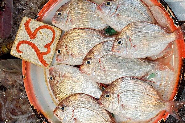 Fish and other designated seafood are traditionally eaten by Catholics on Fridays due to the prohibition on eating meat on that day. Contemporary prac