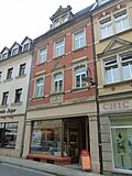 Apartment building with shop in closed development