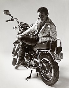 Author and filmmaker Roberta Degnore, seated on her Kawasaki ZL600 and wearing a white leather Vansons motorcycle jacket