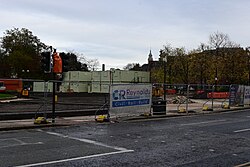 A shut-off pedestrian crossing near a pile of removed paving bricks in the Rose Bowl of Queen's Gardens in Kingston upon Hull.