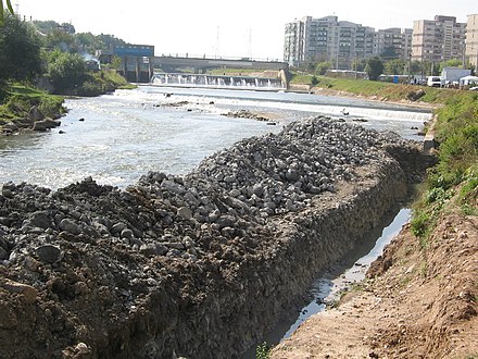 Maintenance of the Somesul Mic River bed, with high rise communist buildings of Grigorescu visible in the rear. Somes reamenajare.jpg