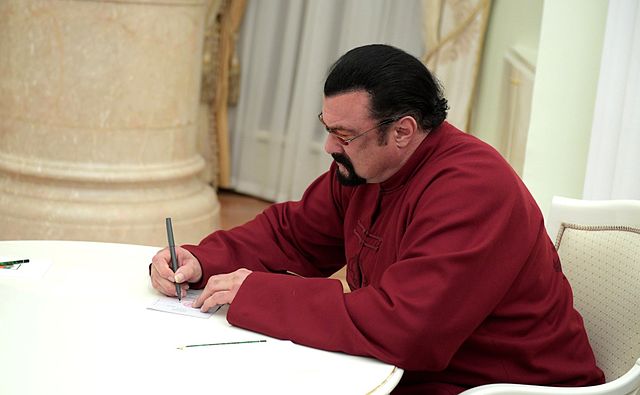 Seagal signing his Russian passport in November 2016