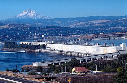 Looking west, fish ladder in the foreground, power generation center. Mount Hood rises in the background.