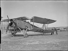 Ground crew moving the folding wing of a Swordfish into position for flying