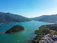 Wu Chau in Three Fathoms Cove. The village on the right is Tseng Tau.