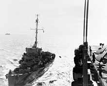 The destroyer escort Crowley transfers a sick crewman onto Sargent Bay. USS Crowley (DE-303) transfers crewman to USS Sargent Bay (CVE-83), 15 January 1945 (80-G-263957).jpg