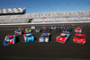 Brightly colored race cars pose for the camera at Daytona.