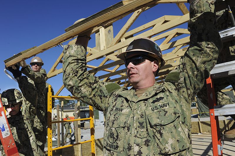 File:A Seabee holds up an A-frame as a hut is taken down. (8516135634).jpg