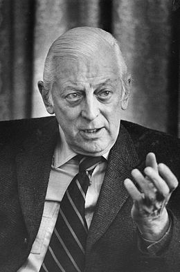 Alistair Cooke, head-and-shoulders portrait, facing front, gesturing with left hand, during interview, March 18, 1974.jpg