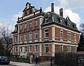 Apartment house in open development with fencing