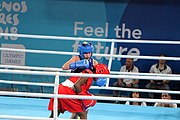 Deutsch: Boxen bei den Olympischen Jugendspielen 2018 Tag 12, 18. Oktober 2018 - Finale Fliegengewicht Mädchen – Martina La Piana (Italien, blau) schlägt Adijat Gbadamosi (Nigeria, rot) 5-0; Ringrichter ist James Beckles (Trinidad und Tobago). English: Boxing at the 2018 Summer Youth Olympics on 18 October 2018 – Girl's flyweight Gold Medal Bout - Martina La Piana (Italy, blue) beats Adijat Gbadamosi (Nigeria, red) 5-0; Referee is James Beckles (Trinidad and Tobago). Español: Boxeo en los Juegos Olímpicos Juveniles de Verano de 2018 en 18 de octubre de 2018 - Combate a medalla de oro de peso mosca para mujeres: Martina La Piana (Italia, azul) le gana a Adijat Gbadamosi (Nigeria, roja) 5-0; El árbitro es James Beckles (Trinidad y Tobago).