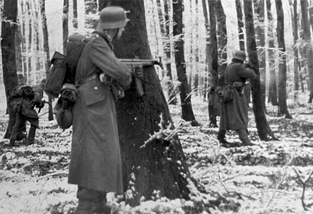 Volksgrenadiers, armed with StG 44 rifles, fighting in the Ardennes, 1944